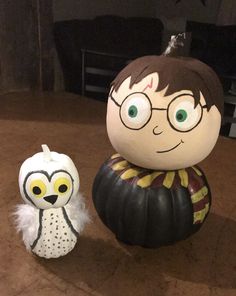 an owl and harry potter pumpkin sitting next to each other