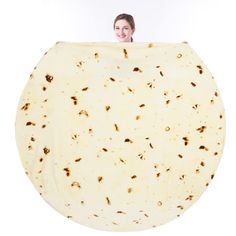 a woman holding up a large tortilla in front of her face on a white background