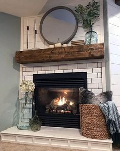 a fireplace with a mirror above it