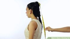 a woman measuring her hair with a tape