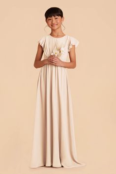 This sweet ruffle-sleeved dress in Champagne is a dream for a junior bridesmaid. Featuring a waistband tie in back for juniors who are between sizes. Perfect for a younger junior bridesmaid or an older flower girl, this frilly-sleeved look is cute as a button. And the hidden side pockets are perfect for stashing her favorite lip balm, instructions for how to save the world, etc.n | Champagne Bridesmaid Dress Chiffon Size Medium | Birdy Grey Celine Junior Older Flower Girl, Jr Bridesmaid Dresses, Champagne Bridesmaid Dress, Jr Bridesmaid, Bridesmaid Dress Chiffon, Champagne Bridesmaid, Birdy Grey, The Wedding Date, Floor Length Skirt