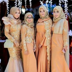 three women in hijabs standing next to each other and posing for the camera