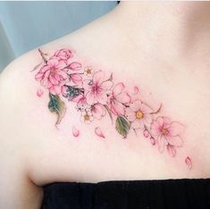 a woman's chest with pink flowers on it