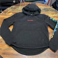 Black North Face Hoodie With Red Lettering On The Front And Brightly Colored Lettering On The Sleeve. Front Pouch Pocket. Sporty Black The North Face Sweatshirt, Sporty Black Sweatshirt By The North Face, Black The North Face Hoodie For Streetwear, The North Face Black Hooded Hoodie, Casual Black The North Face Hoodie, The North Face Winter Sweatshirt With Ribbed Cuffs, Black The North Face Sweatshirt For Fall, The North Face Fleece Sweatshirt With Adjustable Hood, The North Face Hooded Fleece Sweatshirt