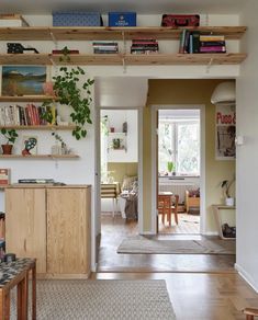 a living room filled with furniture and bookshelves on top of it's shelves