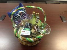 a wicker basket filled with bottles and wine glasses