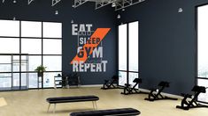 an empty gym room with benches and exercise equipment in front of large windows overlooking the city