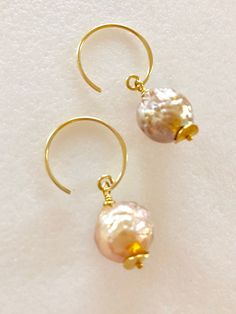 "Soft peach glow Chinese freshwater Kasumi pearls wire wrapped on handmade 24k gold vermeil ear wires Beautiful 11mm Chinese kasumi pearls with characteristic iridescent bumpy surface are full of color and texture and highly lustrous. They display a full array of metallic colors including dusty rose pink, peach and bronze. Stunning kasumi pearls are wire wrapped on 24k gold vermeil handmade ear wires with tiny gold vermeil wavy disc accents. Total length is 1 1/4\". Also in Sterling silver." Handmade Pearl White Pearl Earrings, Dainty Handmade Gold Pearl Earrings, Handmade Delicate Pearl Earrings, Handmade Baroque Pearl Drop Earrings, Delicate Handmade Gold Pearl Earrings, Handmade Delicate Baroque Pearl Earrings, Delicate Handmade Baroque Pearl Earrings, Handmade Baroque Pearl Pear-shaped Earrings, Handmade Baroque Pearl Earrings In Pear Shape