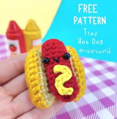 a crocheted hot dog with mustard and ketchup on it's face