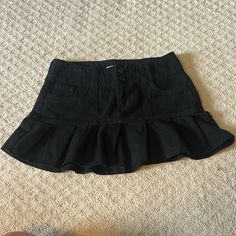 This Skirt Is Brand New, Without The Tags Black Mini Denim Skirt For Summer, Spring Black Mini Denim Skirt, High Waist Black Ruffled Mini Skirt, Black Denim Mini Skirt With Pockets, Black Pleated Mini Denim Skirt, Black Relaxed Skort With Pockets, Casual Black Flared Skirt Bottoms, Trendy Black Ruffled Mini Skirt, Black Relaxed Fit Tiered Skort