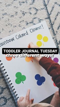 a child is writing on a notebook with the words, rainbow colored clovers toddler journal tuesday three different ways