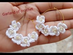 small crochet flower hoop earrings in white with gold accents on the end, handmade by garland of crochet