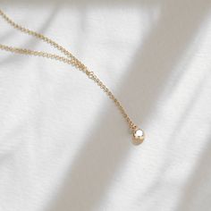 "Loving our new addition! This minimal and cute cubic zirconia lariat necklace will be hard to take off! A must for every girl! P R O D U C T * D E T A I L S - Cubic Zirconia measures 4mm - Chain drop measures 1 inches - Wire wrapping detail - Available in Sterling Silver and 14k Gold Filled C H A I N * U P G R A D E Two is always better than one, which is why you should never be chained down to a single option. For more information regarding our two chain options visit: www.etsy.com/listing/554 Dainty Lariat Necklace With Delicate Chain, Minimalist Dangle Drop Necklace, Minimalist Lariat Necklace As Gift, Minimalist Drop Necklace With Adjustable Length, Everyday Minimalist Lariat Necklace With Simple Chain, Minimalist Lariat Drop Necklace For Everyday, Gold Minimalist Lariat Necklace, Delicate Everyday Lariat Necklace With Clavicle Chain, Minimalist Yellow Gold Lariat Necklace