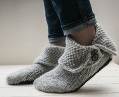 someone is wearing slippers made out of knitted wool and they are standing on a white surface