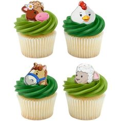 four cupcakes with farm animals on them