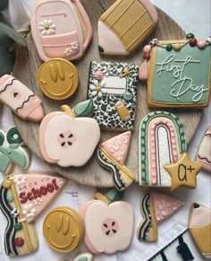 some decorated cookies are on a wooden plate