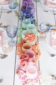 a long table with flowers and candles on it