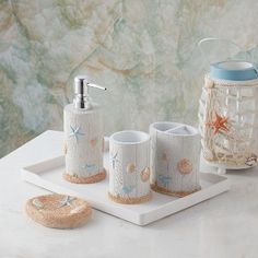 a bathroom set with soap dispenser, toothbrush holder and other items