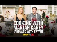 a man and woman standing next to each other in a kitchen with christmas decorations on the counter