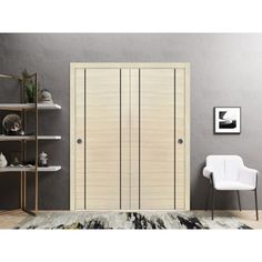 a white chair sitting in front of a book shelf next to a wooden closet door