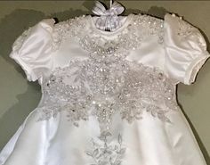 **Please contact me before ordering, to discuss timeframe.  Your wedding dress? Your mom's dress? Or even your Grandmothers vintage wedding gown, make it come to life. Your baby's dress will be made from the wedding dress you supply. The pictures are examples of dresses I have made for other customers.  You will send me your dress, we will discuss sizing and the style you would like and within a week I can have the christening dress in the mail to you. All seams are nicely finished and serged. Elegant Fitted Baptism Dress For Pageant, Elegant Fitted First Communion Dress For Pageant, Fitted Ball Gown For Pageant, Elegant Fitted Wedding Dress For Pageant, Baptism Dress With Fitted Bodice For Pageants, Elegant First Communion Dress With Fitted Bodice For Wedding, White Fitted Dress For First Communion, White Fitted Wedding Dress For First Communion, White Wedding Dress With Fitted Bodice For Pageant