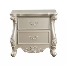 a white nightstand with two drawers and an ornate design on the top, against a white background