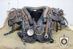 an old motorcycle engine sitting on top of a piece of cloth with chains attached to it