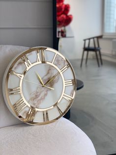 a clock sitting on top of a white couch