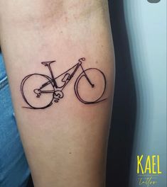 a black and white photo of a bicycle tattoo