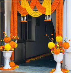 an entrance decorated with orange and yellow flowers