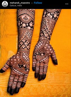 two hands with henna designs on them