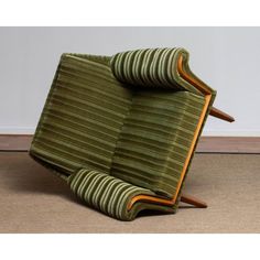 a green chair sitting on top of a carpeted floor