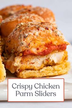 crispy chicken parm sliders on a white plate with text overlay that reads crispy chicken parm sliders