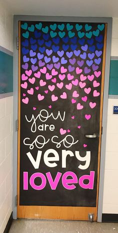 a door decorated with hearts and the words you are very loved