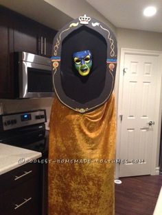 a person in a costume standing in a kitchen