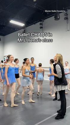 a group of young women standing around each other in front of a ballerinas class