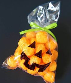 a bag filled with orange candies sitting on top of a table