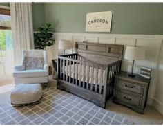 a baby's room with a chair, crib and dresser