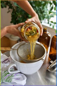 a person pours some liquid into a strainer