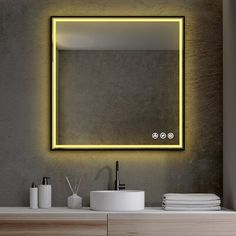 a bathroom with a sink, mirror and lights on the wall next to each other