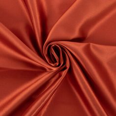 a close up shot of an orange satin fabric