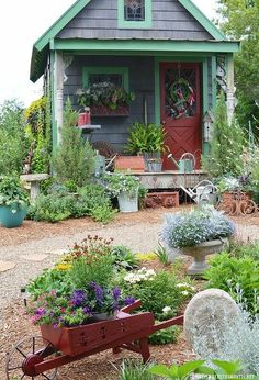 a small house with lots of flowers in the yard