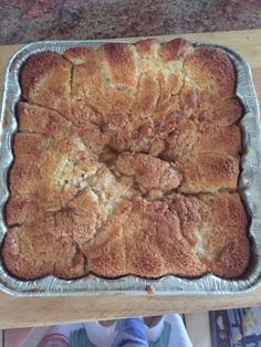 a pan filled with food sitting on top of a wooden table