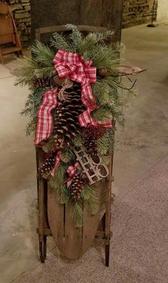 a wooden cart filled with pine cones and christmas decorations