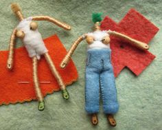 two handmade dolls are laying next to each other