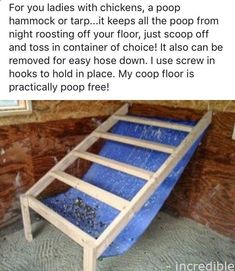 a blue bed frame sitting on top of a floor next to a wooden plank wall