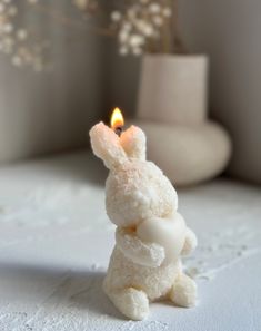 a white bunny candle sitting on top of a table