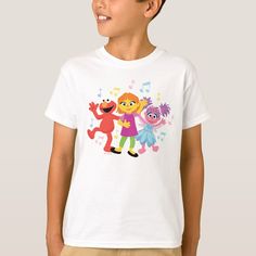 a young boy wearing a sesame street t - shirt