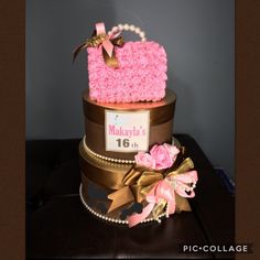 a pink and gold birthday cake on top of a table