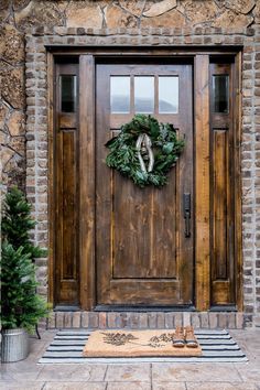 a wooden door with a wreath on it